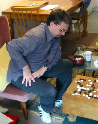 A photograph of Matthew Cocke leaning forward to contemplate his next move
